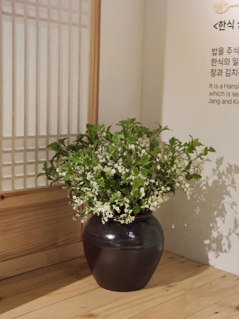 A display of traditional Korean table settings and culinary artifacts inside Hansik Space E:EUM Seoul, showcasing Korea’s food heritage.