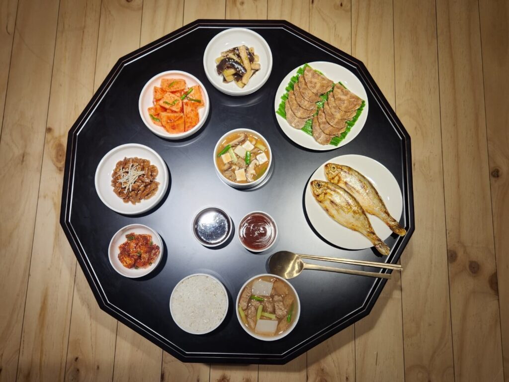 Wide-angle view of a Korean culinary culture exhibition at Hansik Space E:EUM Seoul, featuring food displays and educational panels.